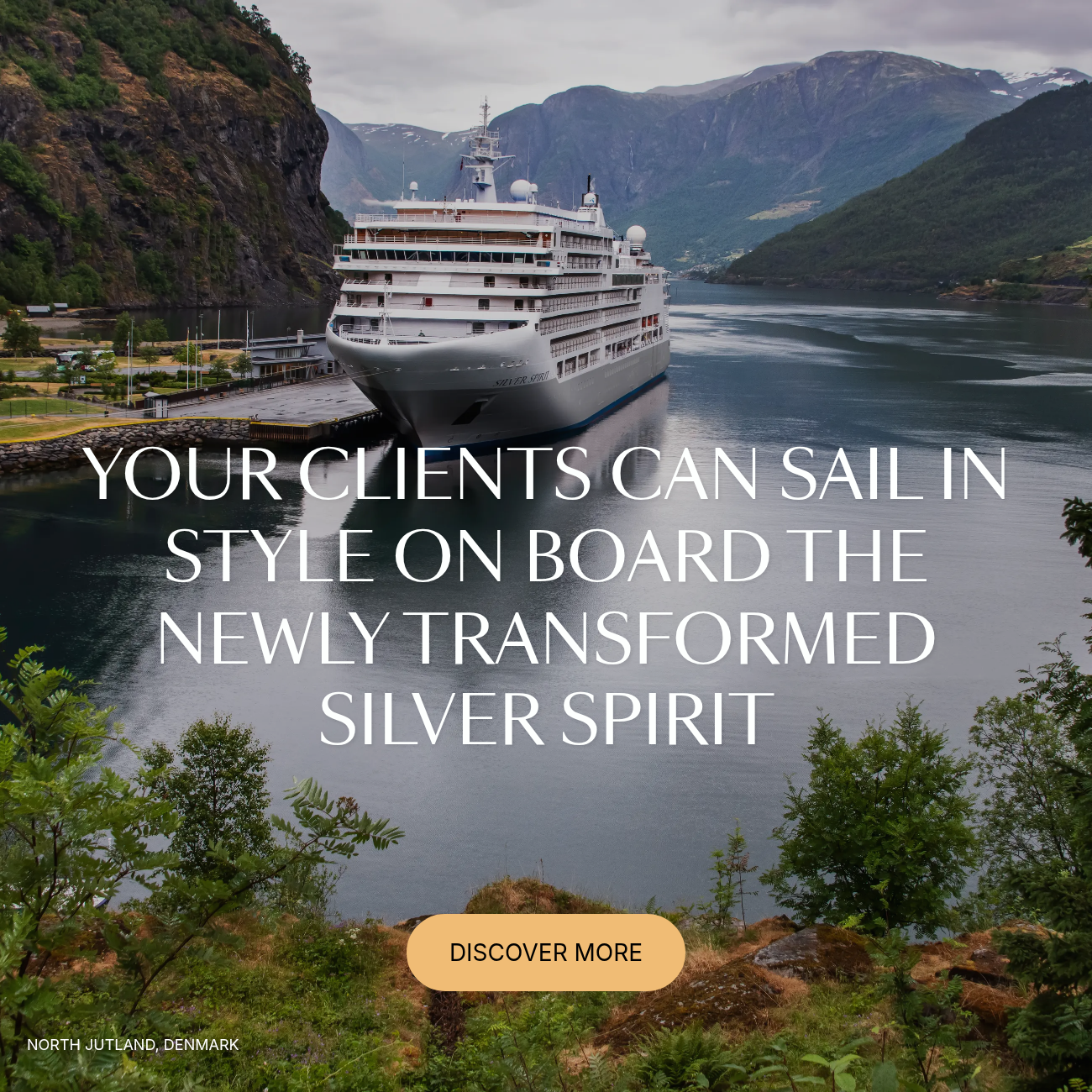 A Silversea cruise ship docked in a scenic Norwegian fjord.