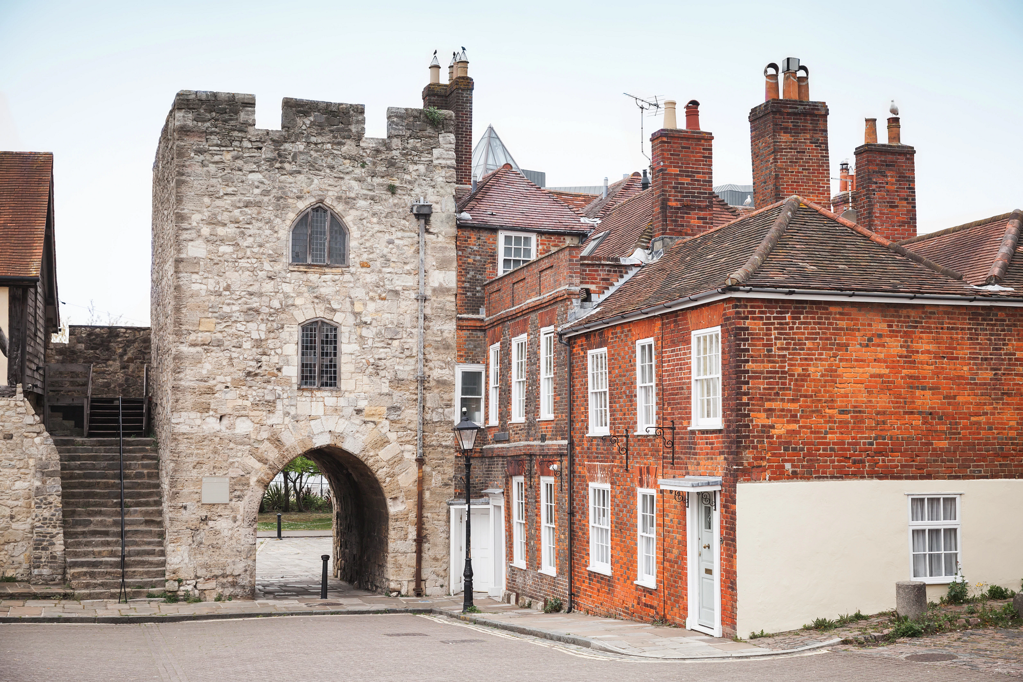 Bargate, a historic stone gatehouse in Southampton, England, next to red brick buildings.