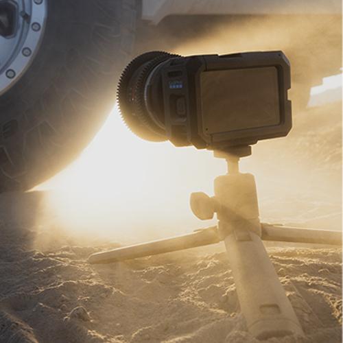 GoPro camera on a tripod in the sand.